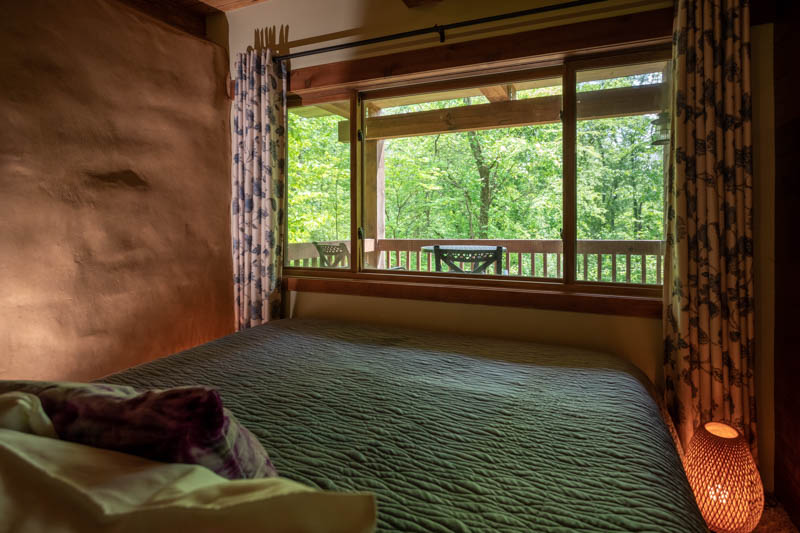 indigo cottage bed with forest view